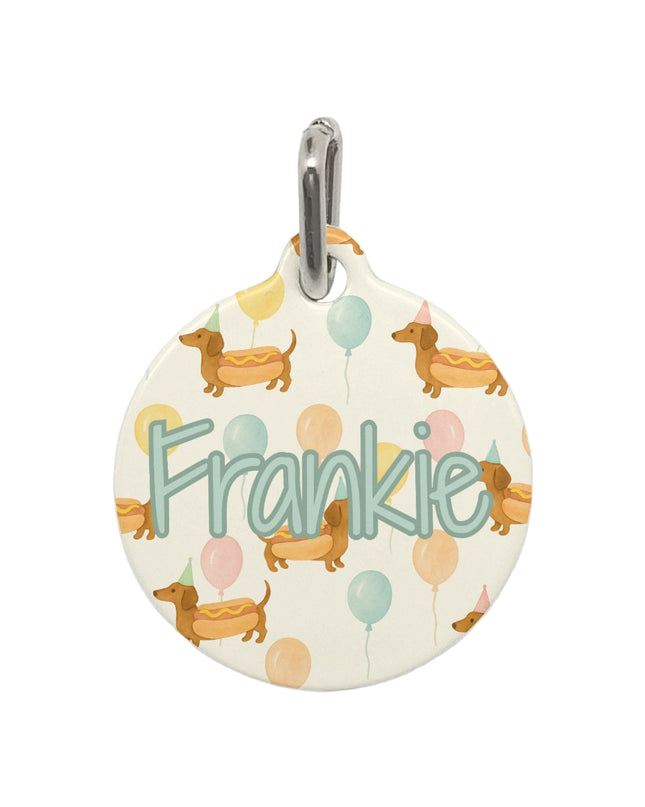Round pet tag with 'Frankie' and dog illustrations on a white background