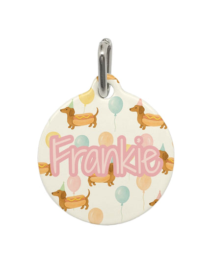 Round pet tag with 'Frankie' and dog illustrations on a white background