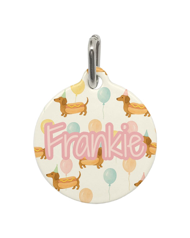 Round pet tag with 'Frankie' and dog illustrations on a white background