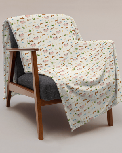 Coastal dachshund blanket draped over chair in lifestyle photo with surf van print