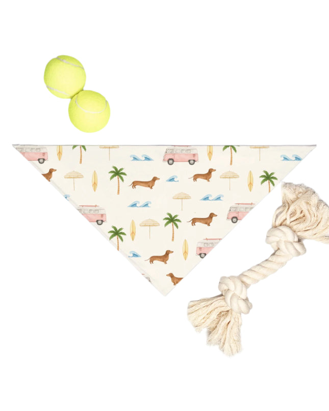 Folded small breed bandana showing soft fabric and sausage dog beach pattern