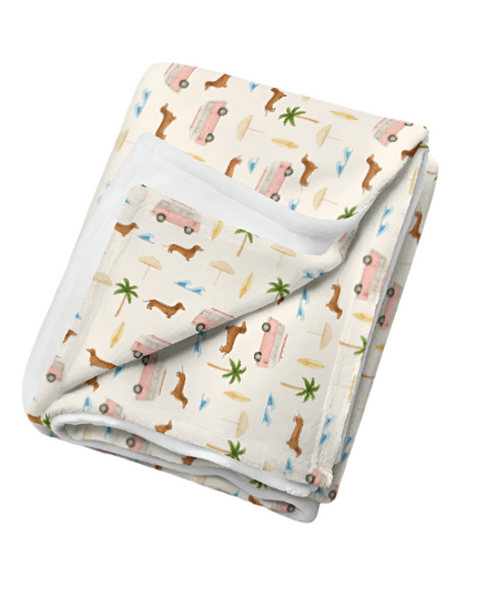 Soft dachshund blanket with surf van and palm tree print in beachy coastal colors