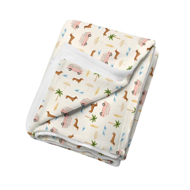 Soft dachshund blanket with surf van and palm tree print in beachy coastal colors