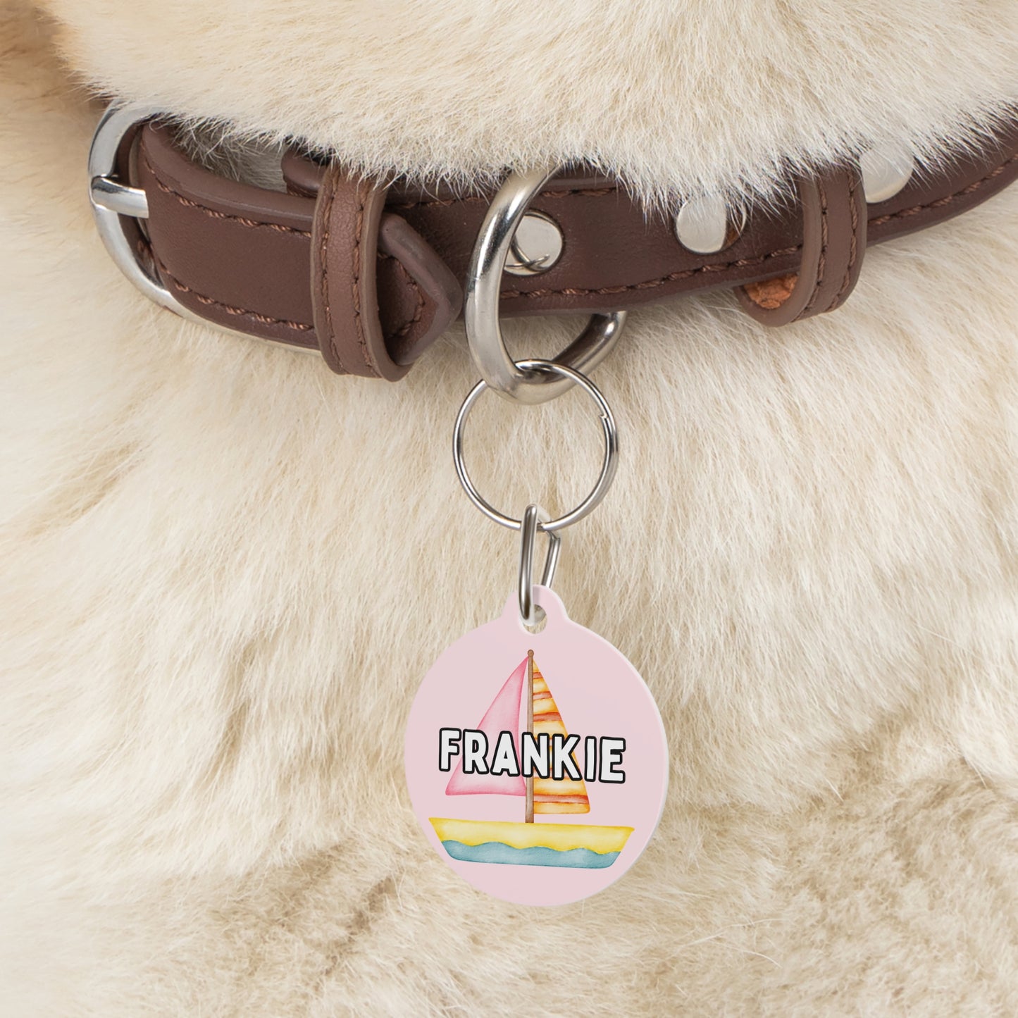 Customizable pink pet tag featuring pink sailboats, green palm trees, and your pet’s name, with a durable metal construction and clip by My Doxie Depot